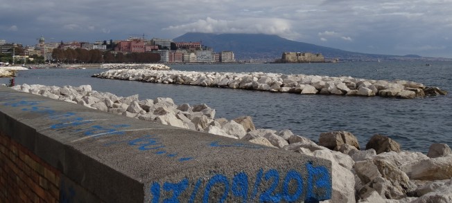 Vesuvius, head in the clouds, watches the Bay of Naples