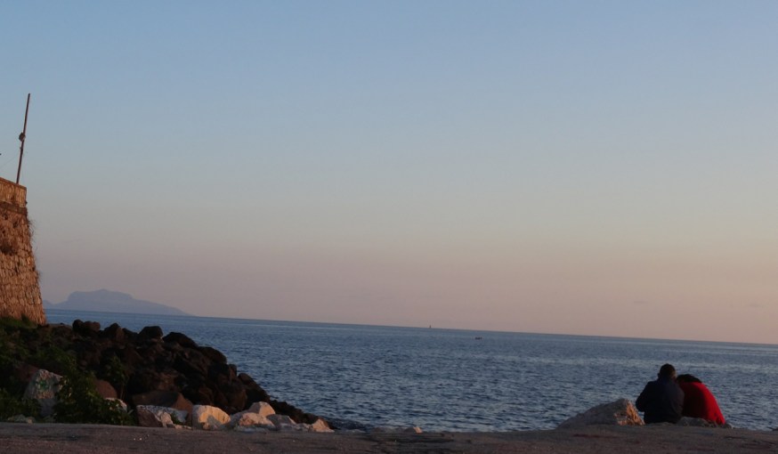 Lovers on the seawall in Pozzuoli