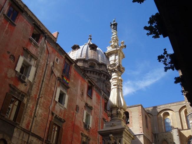 Close to Pio Monte de la Misericordia is the Guglia di San Gennaro (1636) with San Gennaro on the top and the dome of the Capella di San Gennaro behind