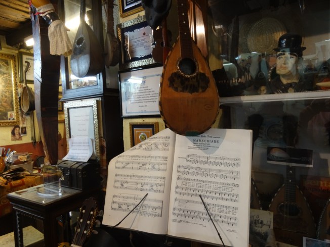 Crowded 'Bottega del Mandolino' in Naples, Italy