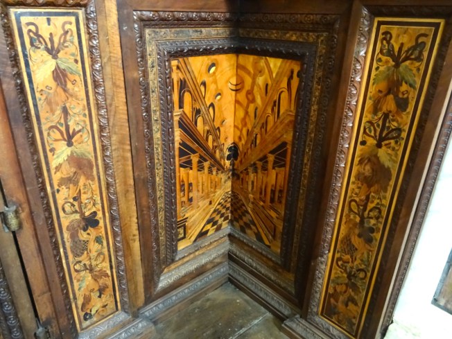 Detail of inlay work in a wooden corner cupboard in the Certosa di San Martino in Naples, Italy