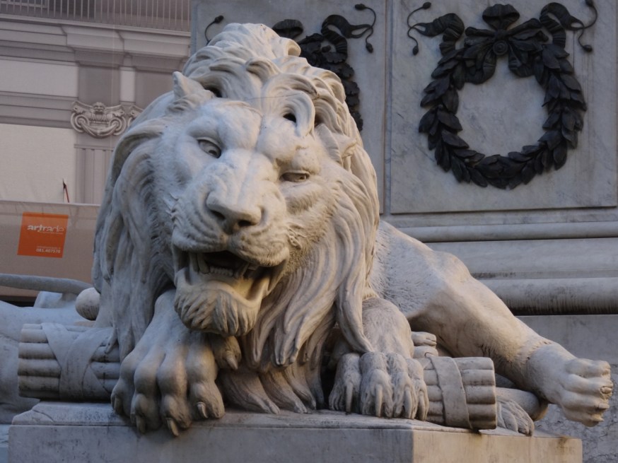 One of the four lions in the Piazza dei Martiri