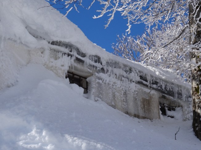 Ice-covered hut at the top of the slopes at Lago Laceno , near Avellino in Italy