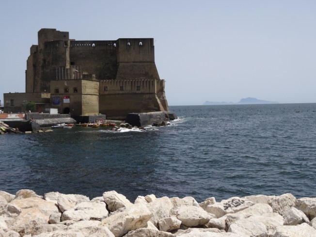 Castel dell'Ovo in Naples, Italy with Capri in the background