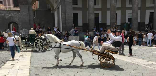 Parade of carriages in the Piazza del Plebiscito in Naples, Italy