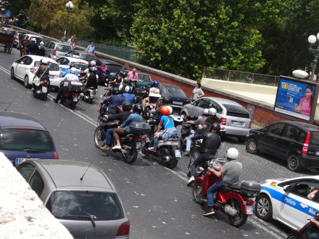 The carriages make their way back through the traffic in Naples, Italy