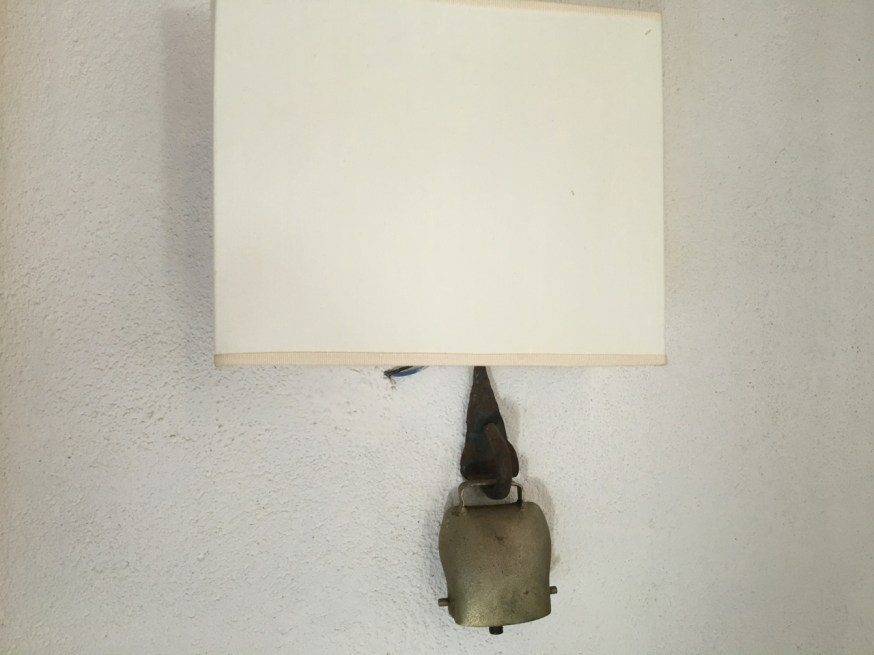 Goat bells hung beneath the lights in our bedroom in Le Stelle di Giurò in Cilento, Italy