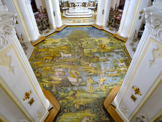The hand-painted ceramic floor in the church showing Adam and Eve's expulsion from the garden of Eden (1761)