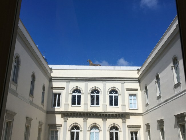 Internal courtyard of the Museo Madre in Naples, Italy with art by Mimmo Paladino on the roof