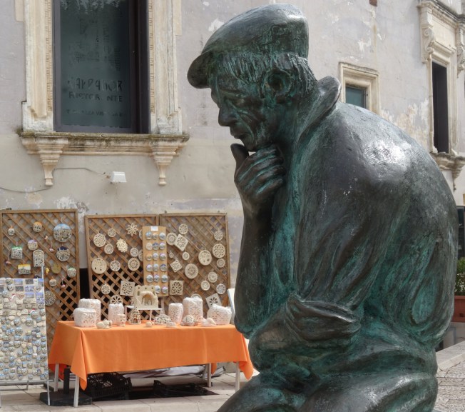 Statue in the square that overlooks the old cave houses in Matera, In Basilicata in Italy